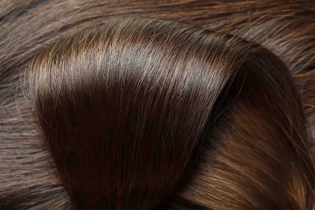 Dark female hair on whole background, close up